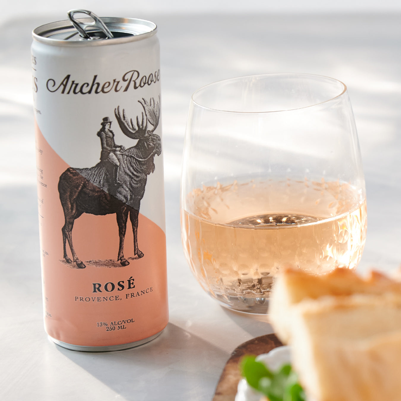 
                  
                    Archer Roose Rose Wine in a Can on a reflective surface | Archer Roose Wines | Wine in a Can | Canned Wine | Luxury Wine. In Cans | Rose | French Rose | Pays D'Oc
                  
                